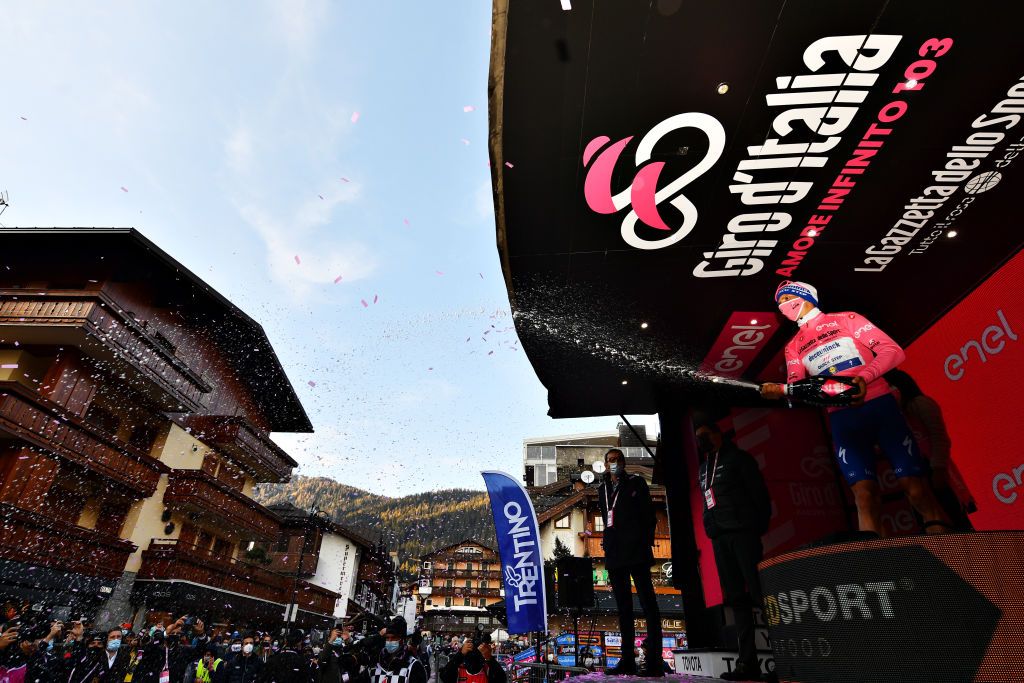 MADONNA DI CAMPIGLIO ITALY OCTOBER 21 Podium Joao Almeida of Portugal and Team Deceuninck QuickStep Pink Leader Jersey Celebration Champagne during the 103rd Giro dItalia 2020 Stage 17 a 203km stage from Bassano del Grappa to Madonna di Campiglio 1514m girodiitalia Giro on October 21 2020 in Madonna di Campiglio Italy Photo by Stuart FranklinGetty Images