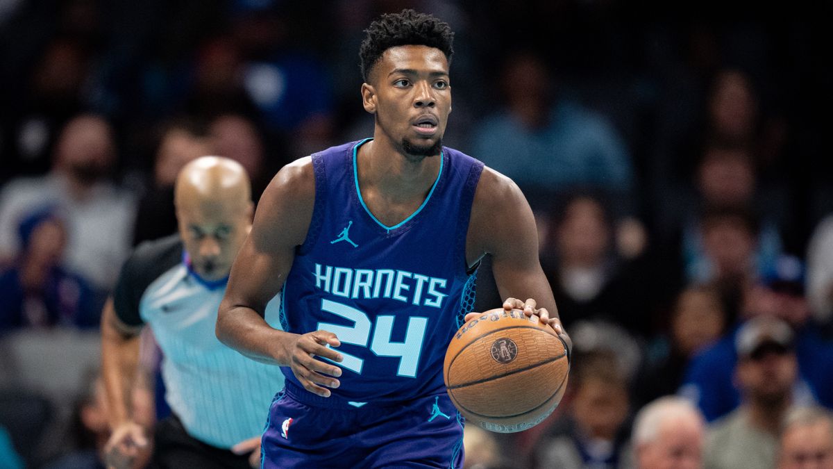 Brandon Miller dribbling the basketball in his blue Charlotte Hornets vest.