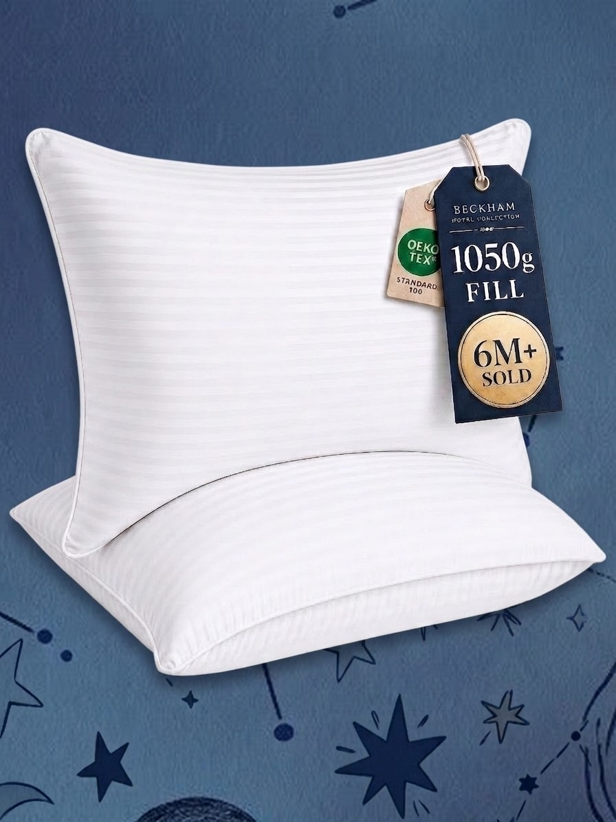 Two Beckham Hotel Collection pillows against a blue background of stars, edited by Gemini