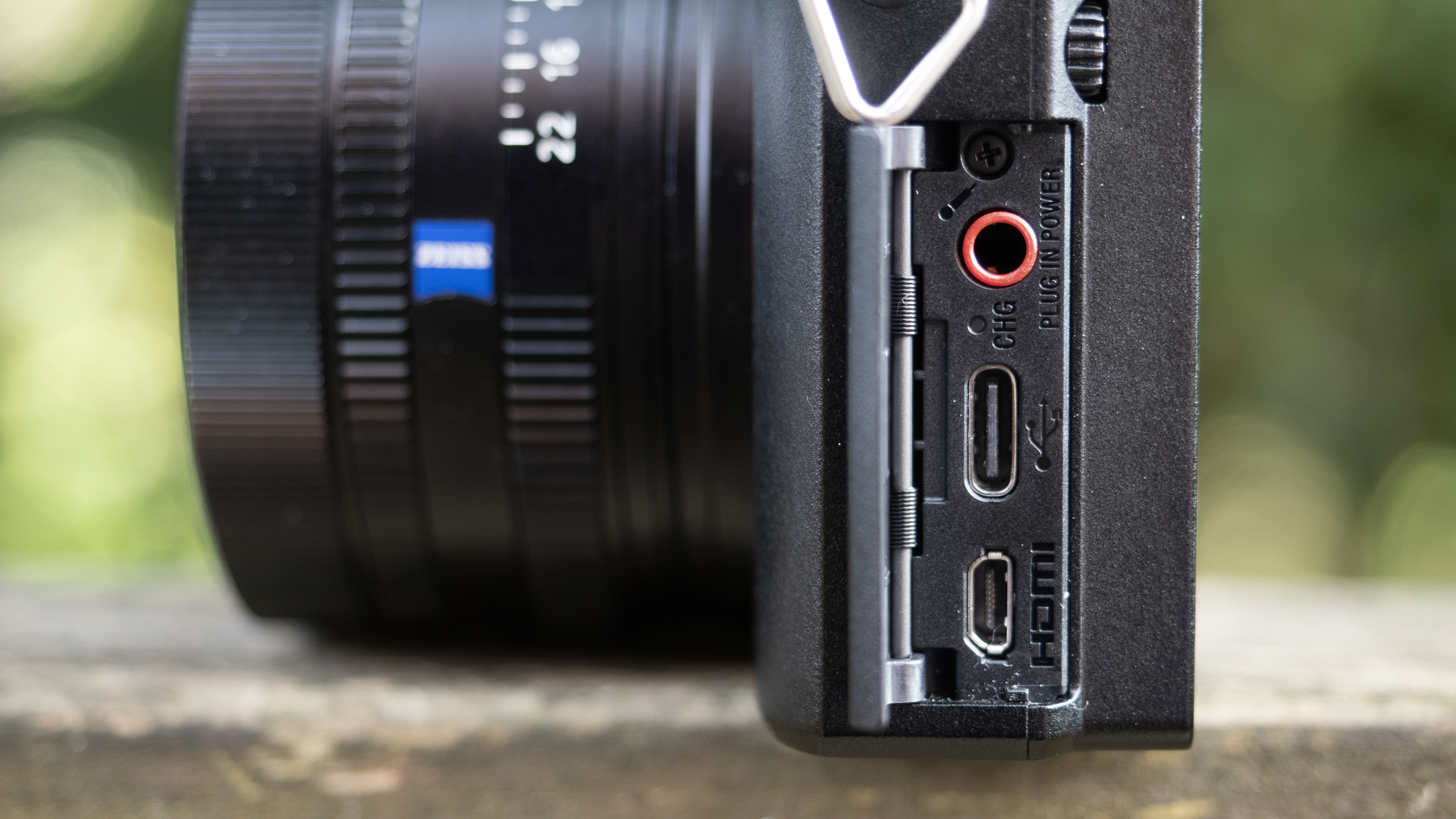 Sony RX1R III on a wooden surface in a woodland environment
