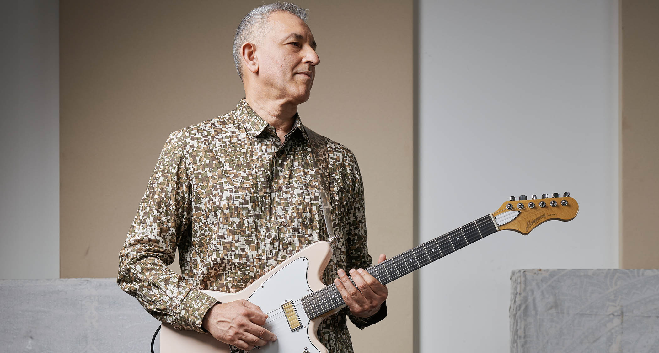 Aziz Ibrahim is photographed at home with some of his favourite guitars