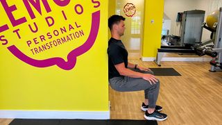 PT Sam Shaw demonstrating the wall sit hold