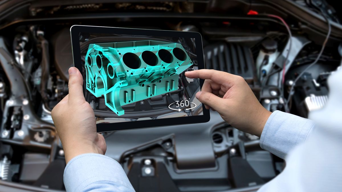 A person looking at a digital representation of an engine