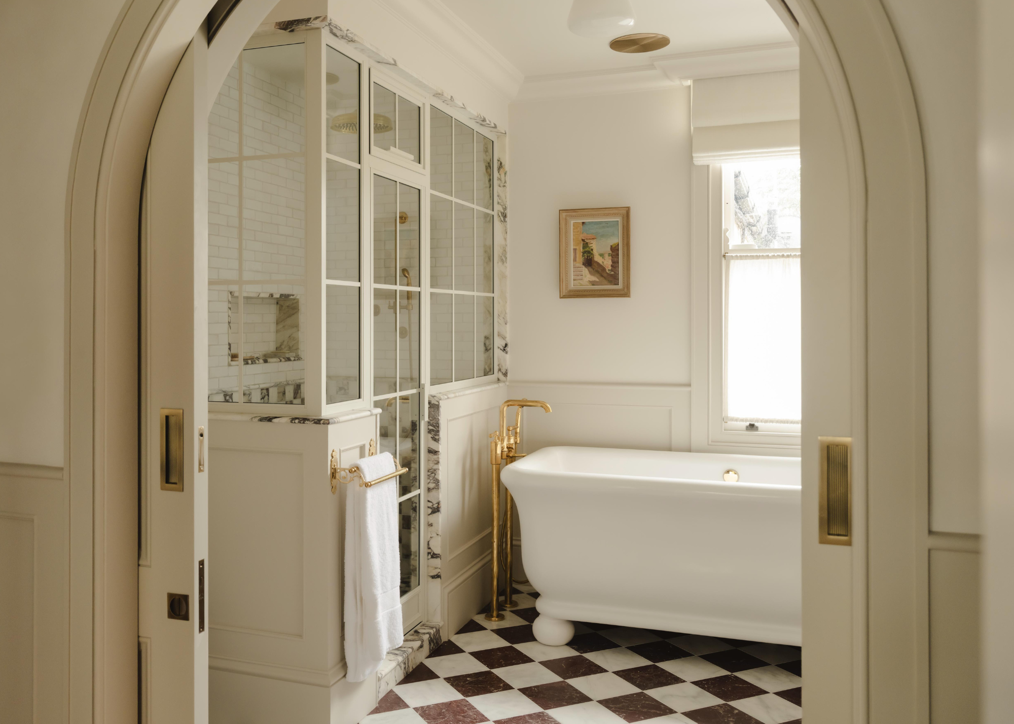checkered floor bathroom with freestanding tub and a big, marble conservatory shower