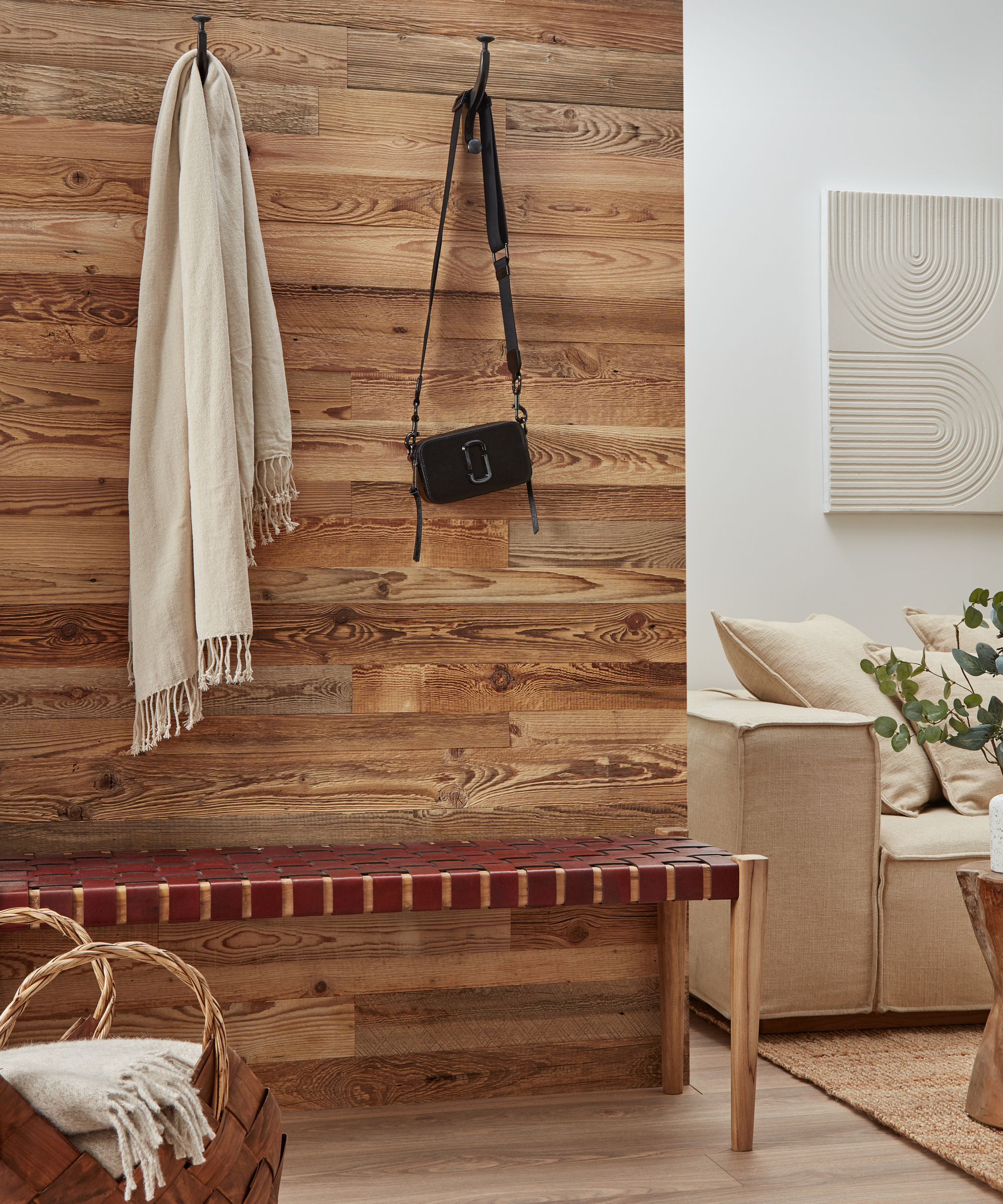 wooden horizontal strips of wood on hallway wall with bench in front and hooks on walls