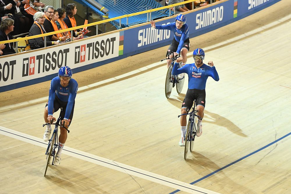 Italy's team members react as they cross the finish line to win the men's Team Pursuit bronze medal race during the UCI Track Cycling World Championships