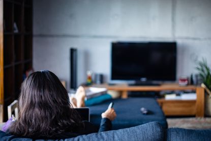 back of the head of a person watching TV 