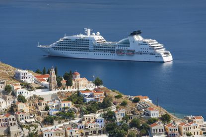 Booking a cruise ship in the bay, Gialos, Symi, Greece