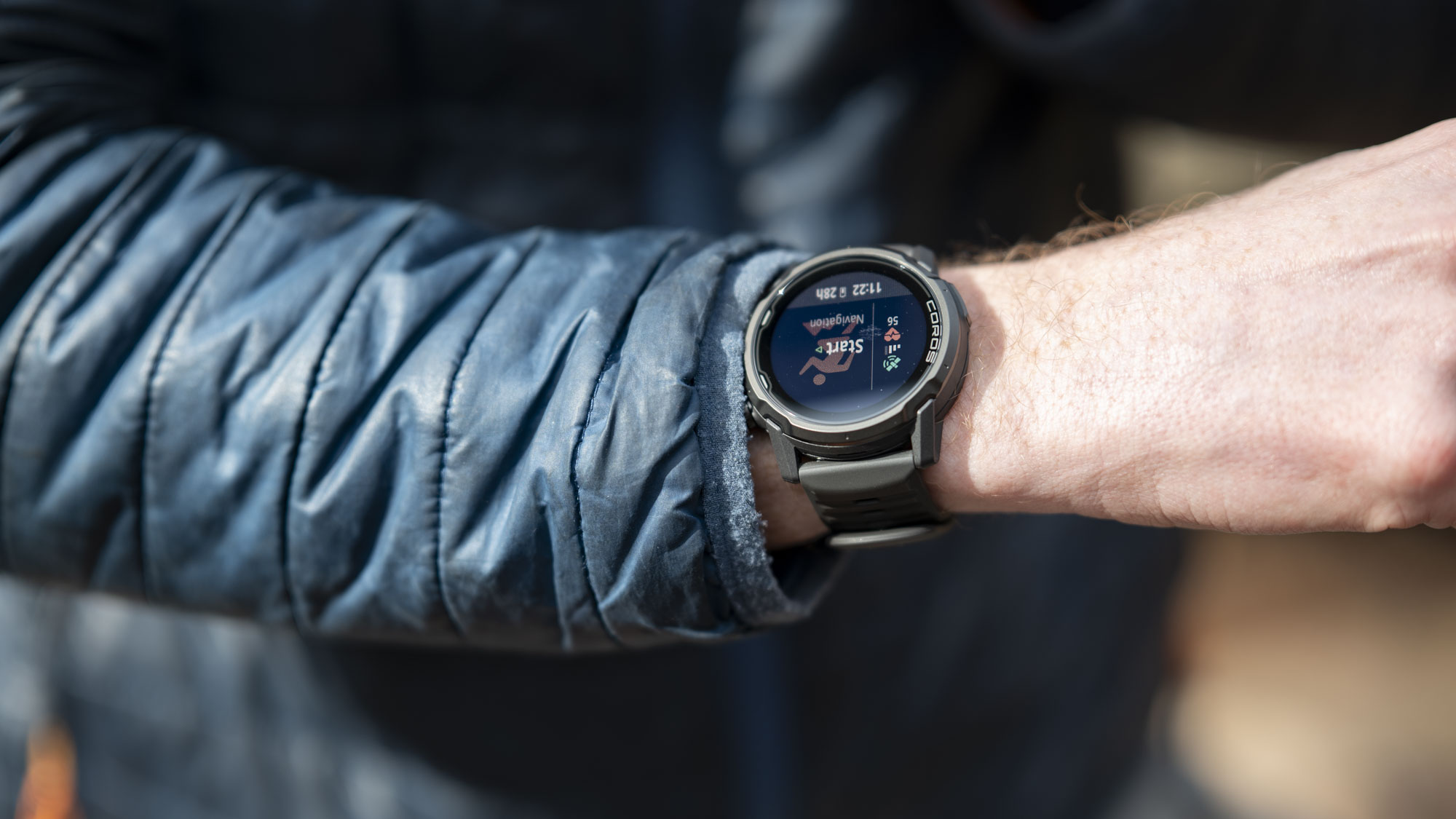 Coros Apex 4 running watch on athlete's wrist, they are starting an outdoor run