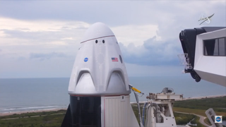 The crew access arm swings away from the Demo-2 SpaceX Crew Dragon capsule on May 27, 2020. Bad weather nixed a planned liftoff on that day.