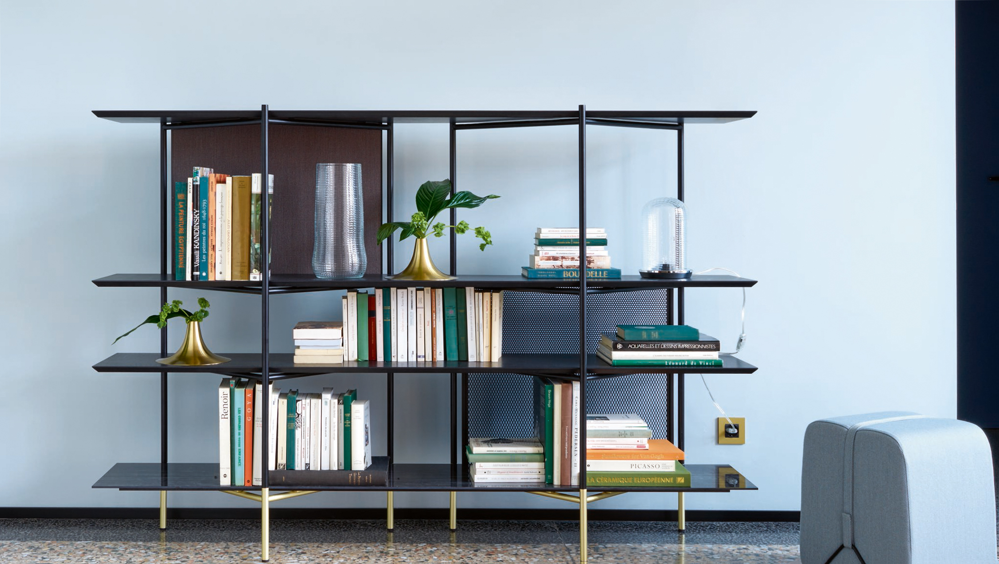 Expert tips on sourcing, large bookshelf with antiques and other treasures in a living room