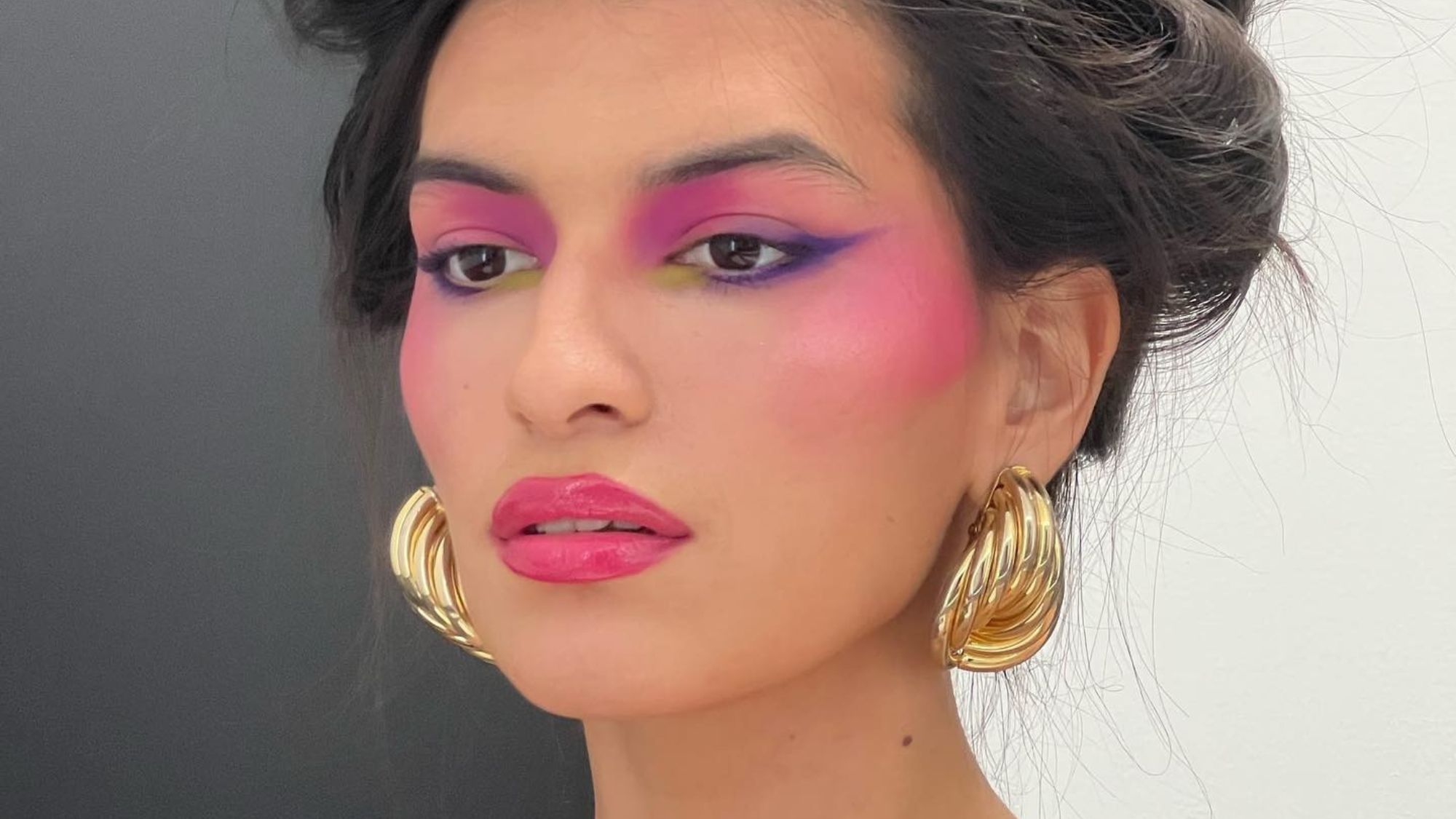 Model wearing colorful editorial makeup.