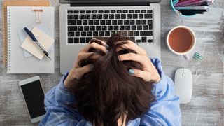 7 anxiety tips: image shows stressed woman in home office