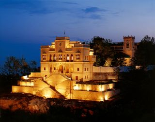 The Ananda main building in the Himalayas illuminated at night