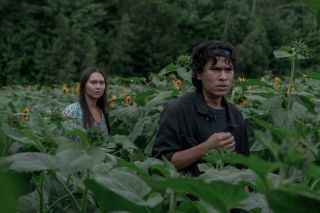 Donna and Manny surrounded by plants in Pet Sematary: Bloodlines
