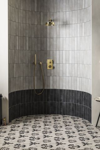 Monochrome wetroom with band of black tiles and monochrome floral patterned floor