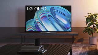 The LG B2 TV in a living room displaying a blue abstract pattern