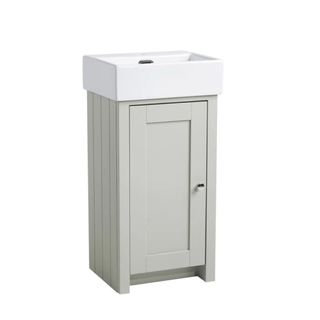 A slimline bathroom vanity unit with sage wainscoting and a compact basin 