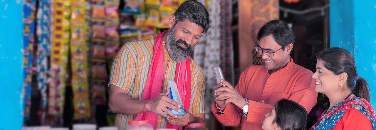 Shop owner taking payment from customers