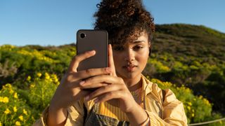 A woman holding a smartphone