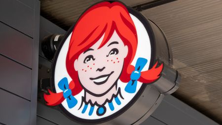 Wendy's logo featuring a red haired girl with freckles and pigtails