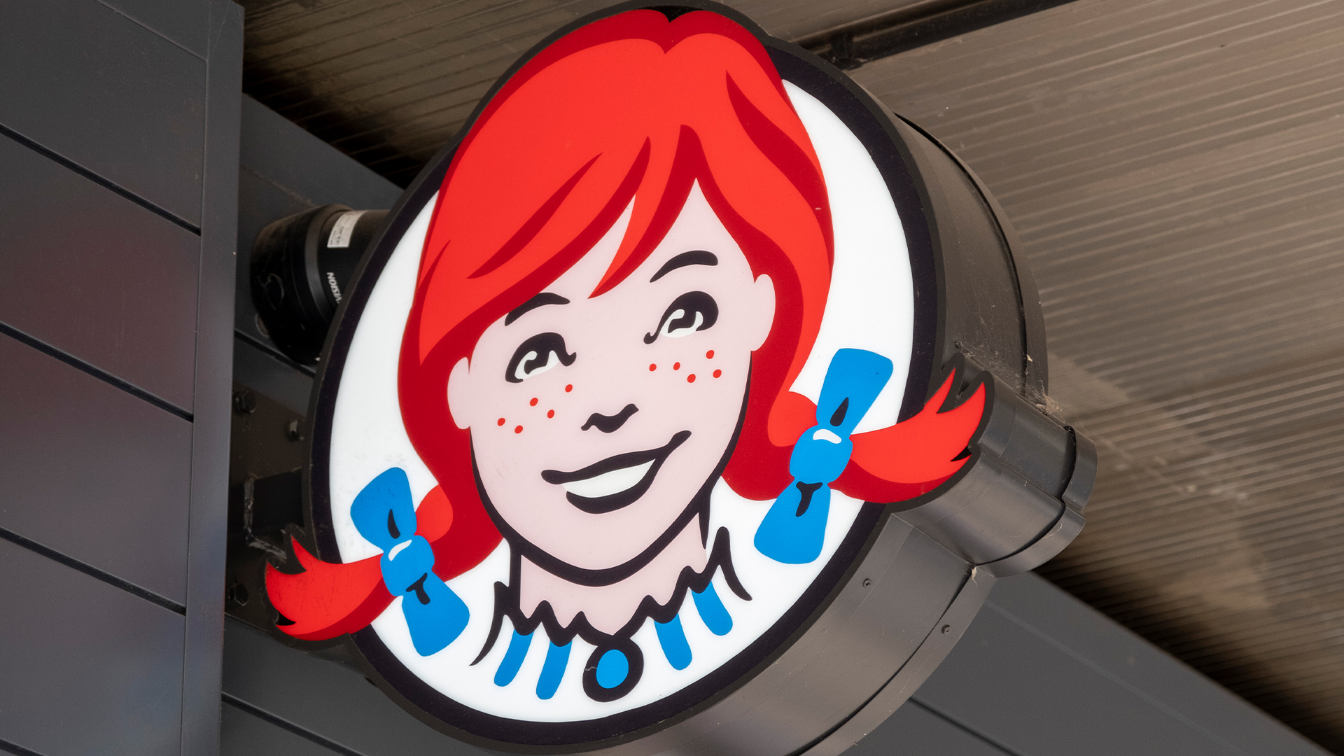 Wendy's logo featuring a red haired girl with freckles and pigtails