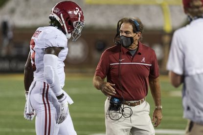 Alabama head coach Nick Saban, right, talks with Daniel Wright as he walks off the field during the second half of an NCAA college football game against Missouri, Saturday, Sept. 26, 2020, in