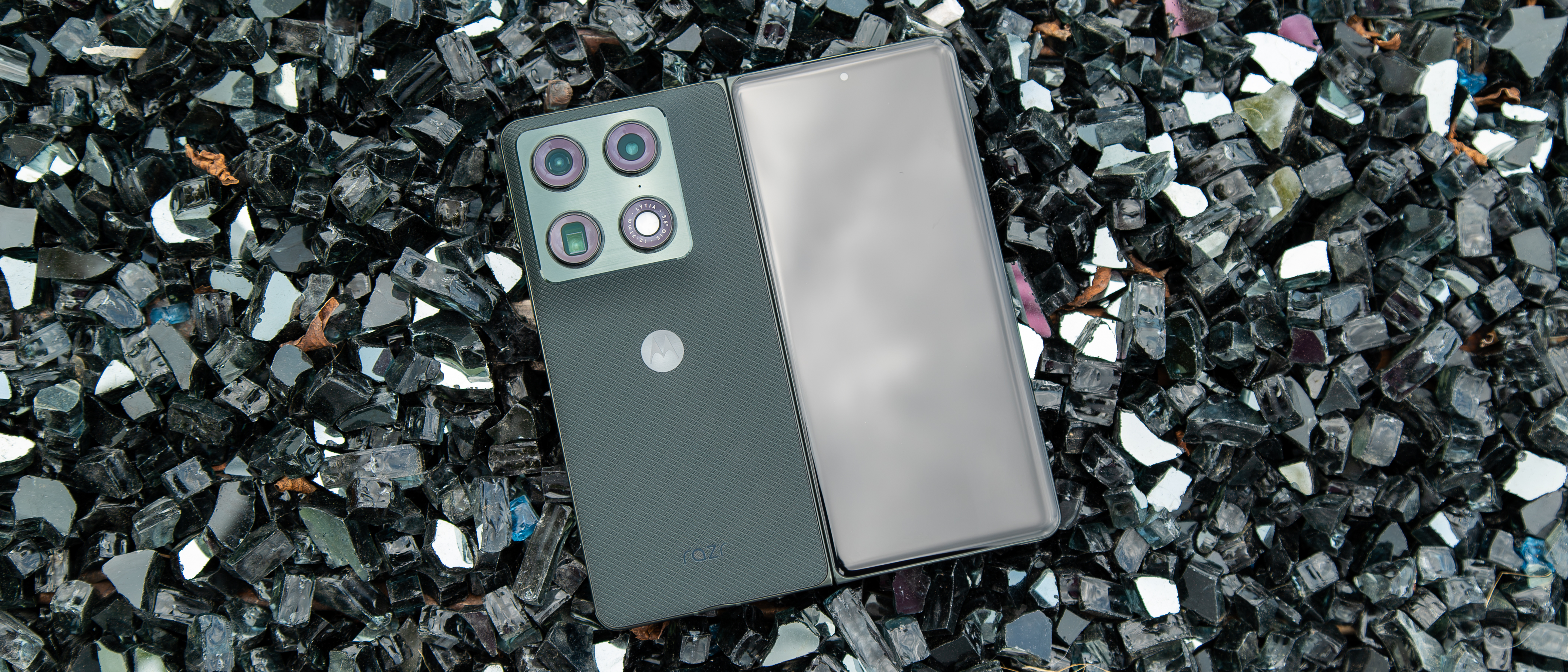 The Motorola Razr Fold on a pile of black crystal rocks