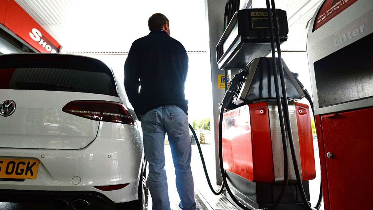 A man refuels at a petrol station