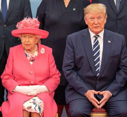 Queen Elizabeth II and US President Donald Trump sit together as they pose for the official family photograph during an event to commemorate the 75th anniversary of the D-Day landings, in Portsmouth, June 5, 2019. (Photo by JACK HILL/POOL/AFP via Getty Images)