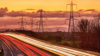 UK Power Networks energy supply image showing electricity pylons at dusk with the M52 motorway in the foreground.