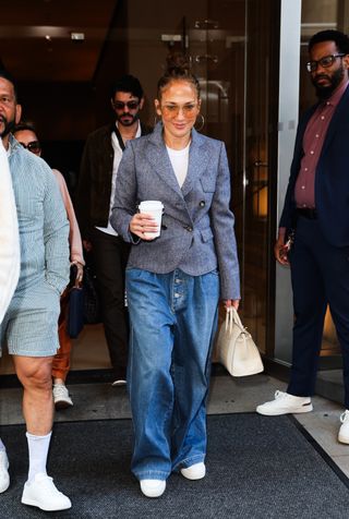 jennifer lopez wearing a blazer, white tee, and jeans