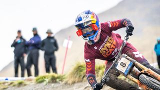 Laurie Greenland riding in Syndicate colors at Fort William downhill