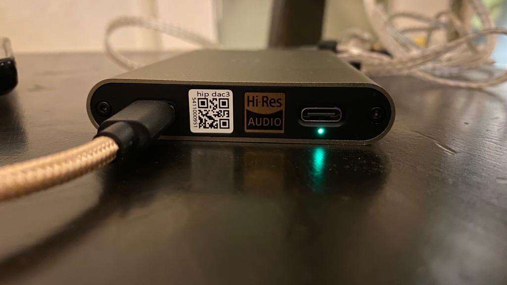 iFi hip-dac 3 detail of USB-C charging port, on black table