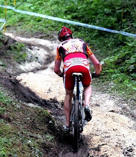 A rider faces mud and wood shavings on the course