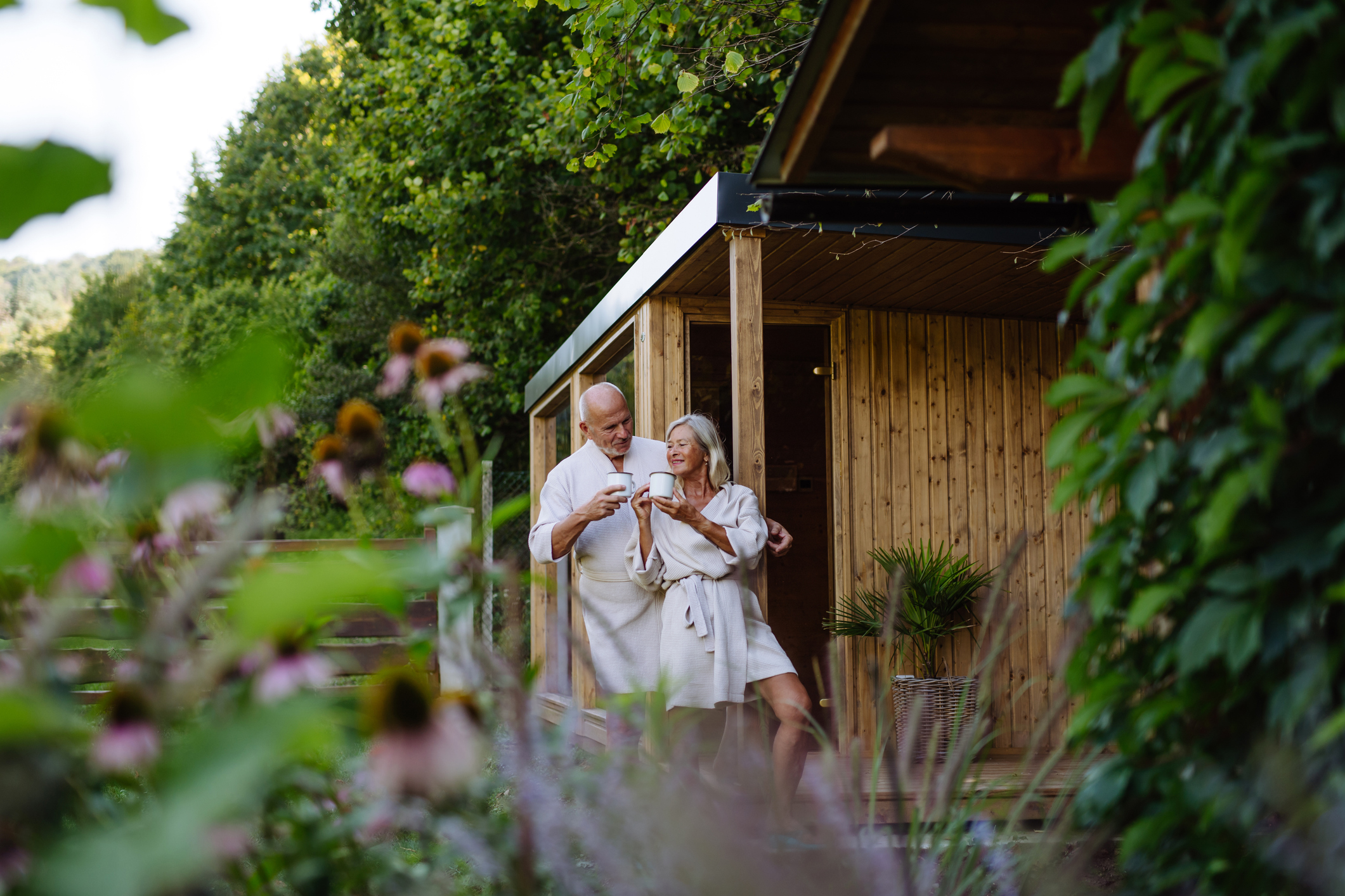 Garden outdoor sauna concept with elderly couple