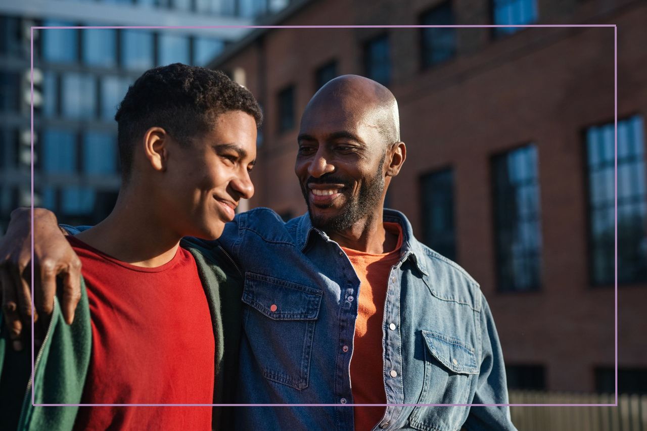 Father walking with his teenage son in a city.