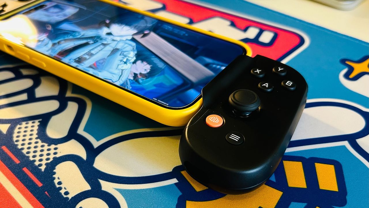 The right hand grip of the Backbone One 2nd Gen on a bright blue desk mat.