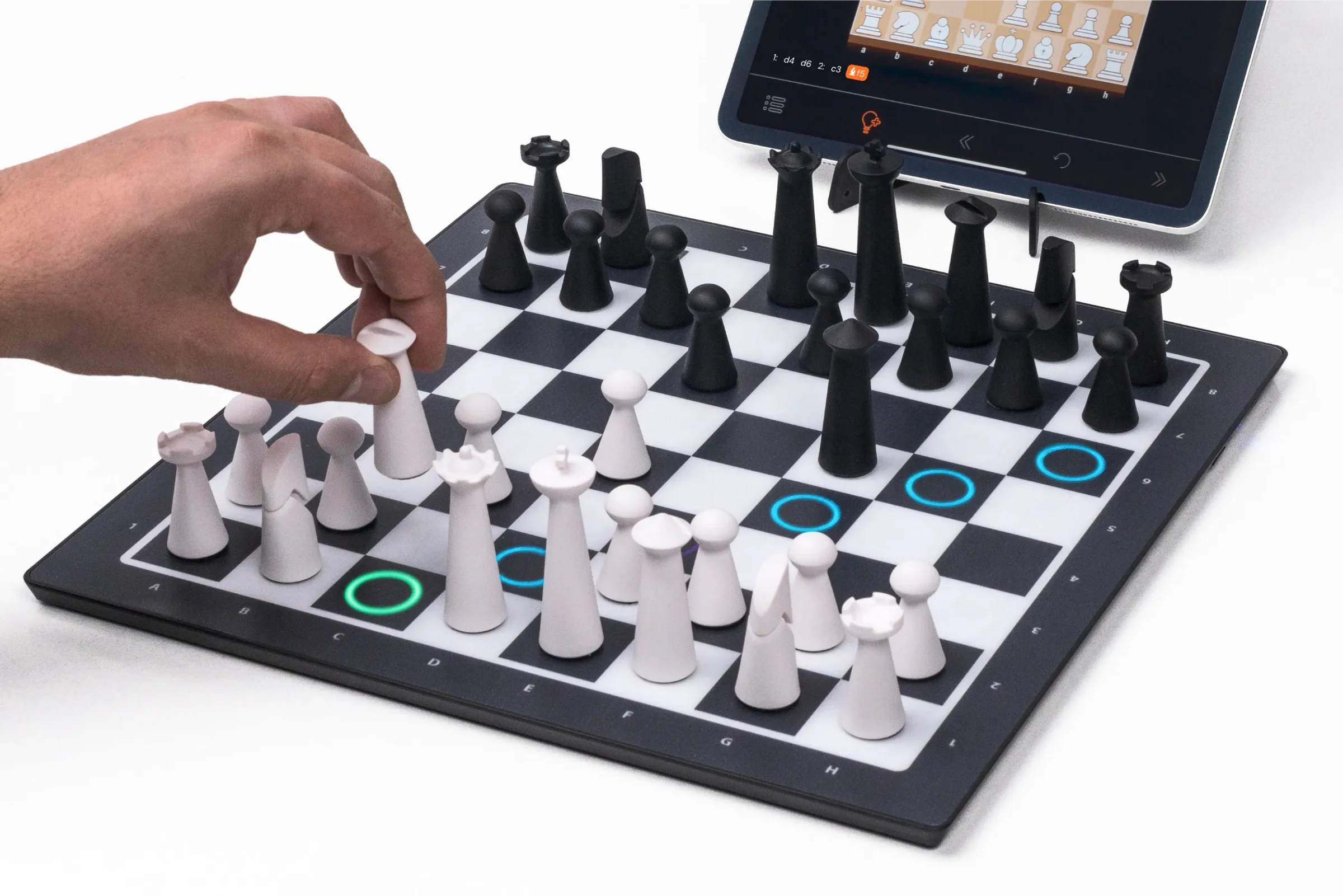 A person moves a chess piece on the GoChess Mini board