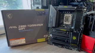 A photo of the MSI MAG Z890 Tomahawk WiFi motherboard, next to its retail packaging.