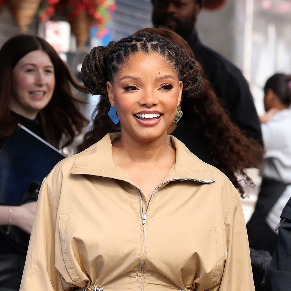 Halle Bailey wearing a tan jacket and matching skirt with white heel sandals 