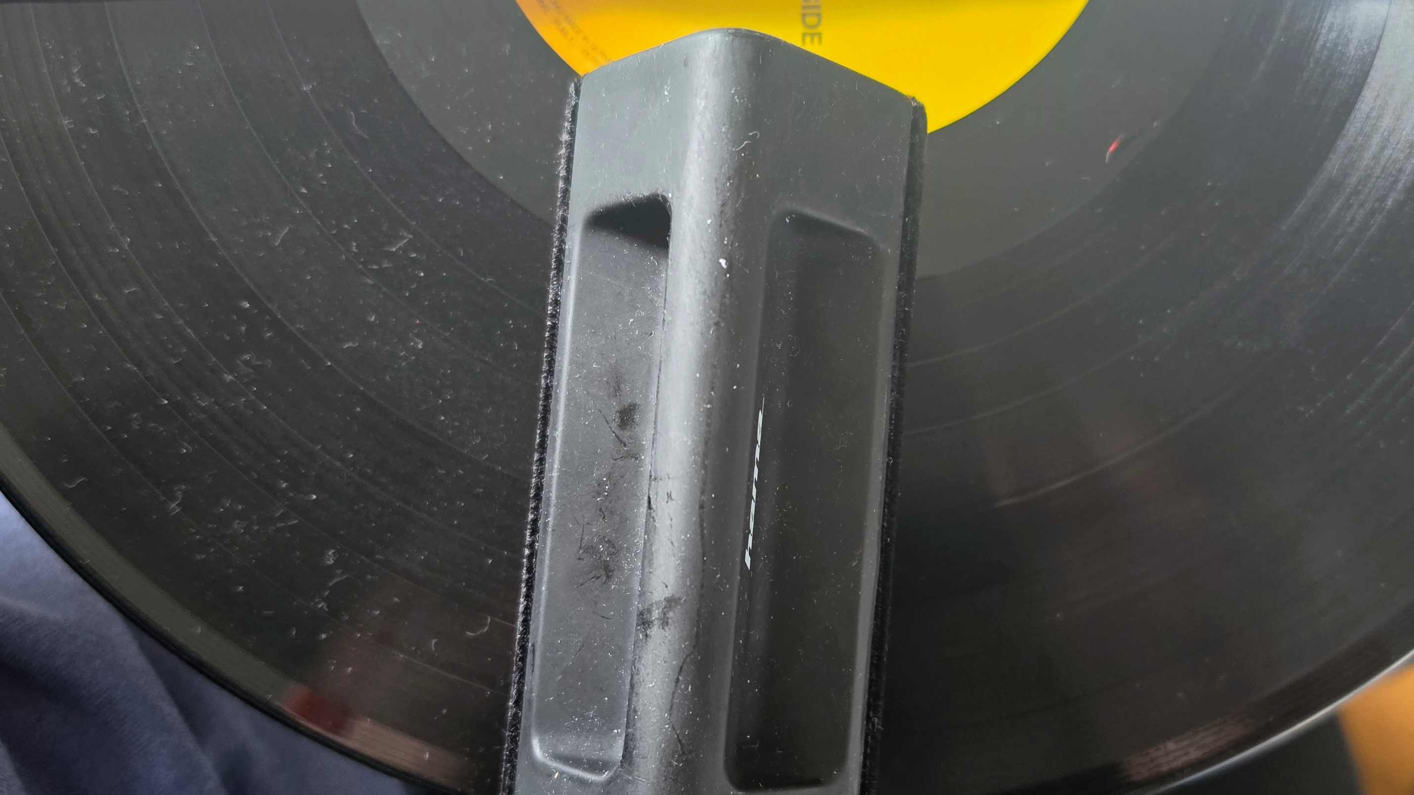 A wiper on a vinyl, that's dusty on one side and clean on the other.