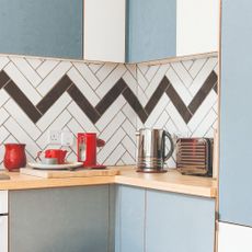 Kitchen with kitchen appliances and graphic tiled backsplash