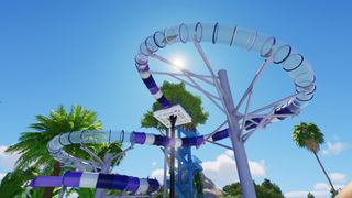 A curling purple waterslide silhoutted against a blue sky.