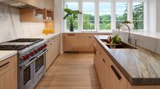 wooden kitchen with stone worktops and large range cooker