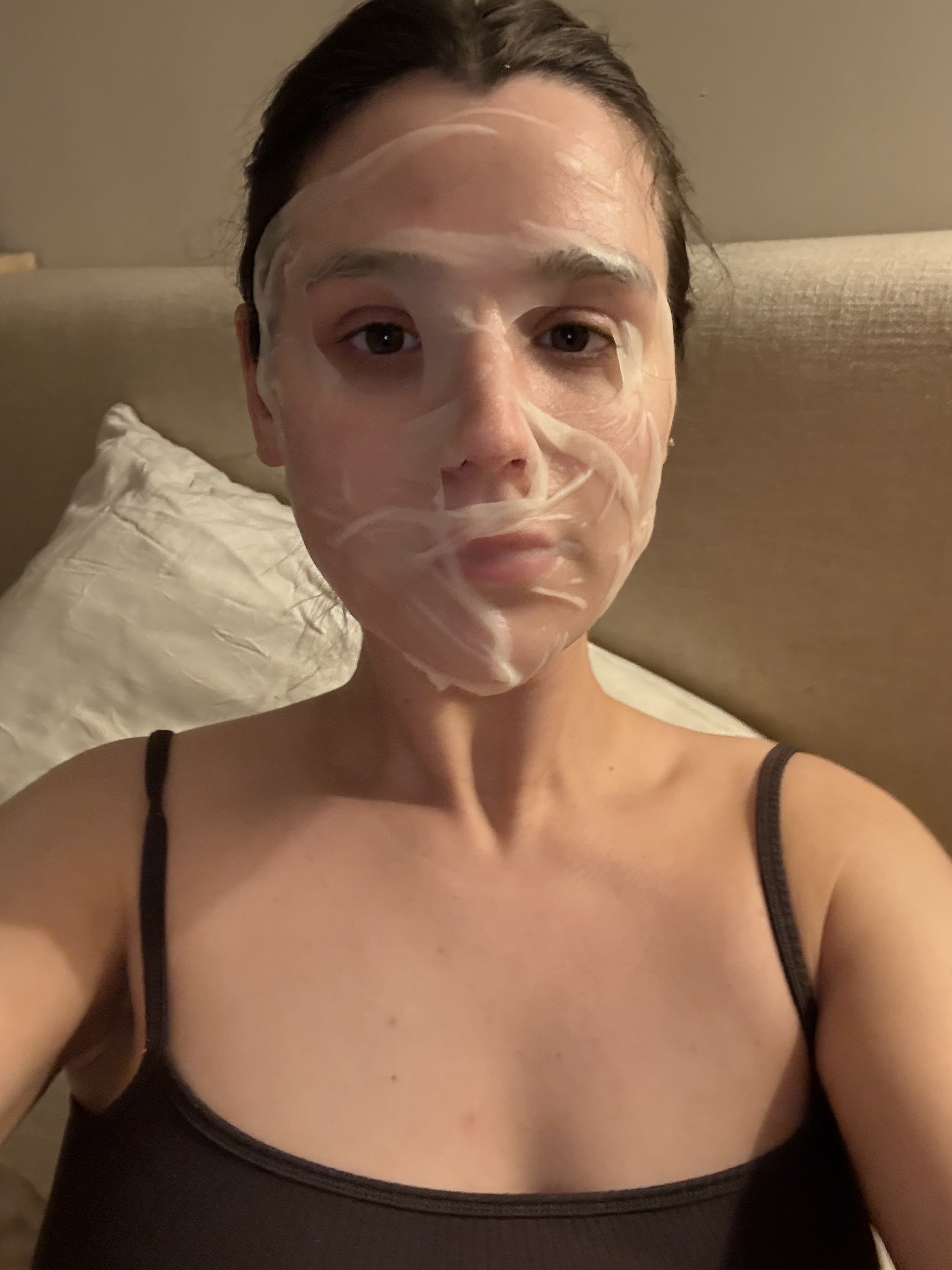 girl with brown tank top with a face mask