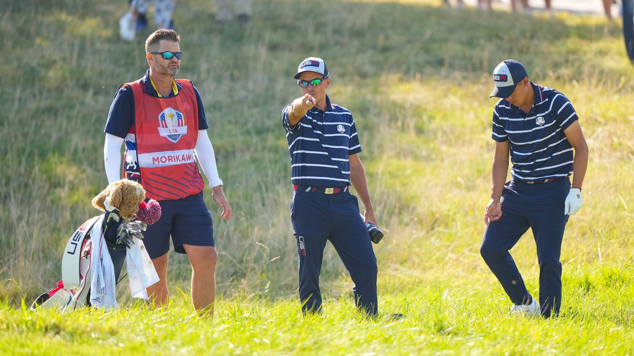 Rickie Fowler helps to line up Collin Morikawa&#039;s shot during Friday morning&#039;s foursomes at the Ryder Cup