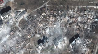 Maxar Technologies’ WorldView-3 satellite captured this photo of apartment buildings and homes in the Ukrainian city of Mariupol destroyed by Russian shelling.