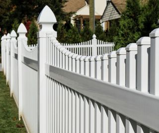 A white vinyl picket fence