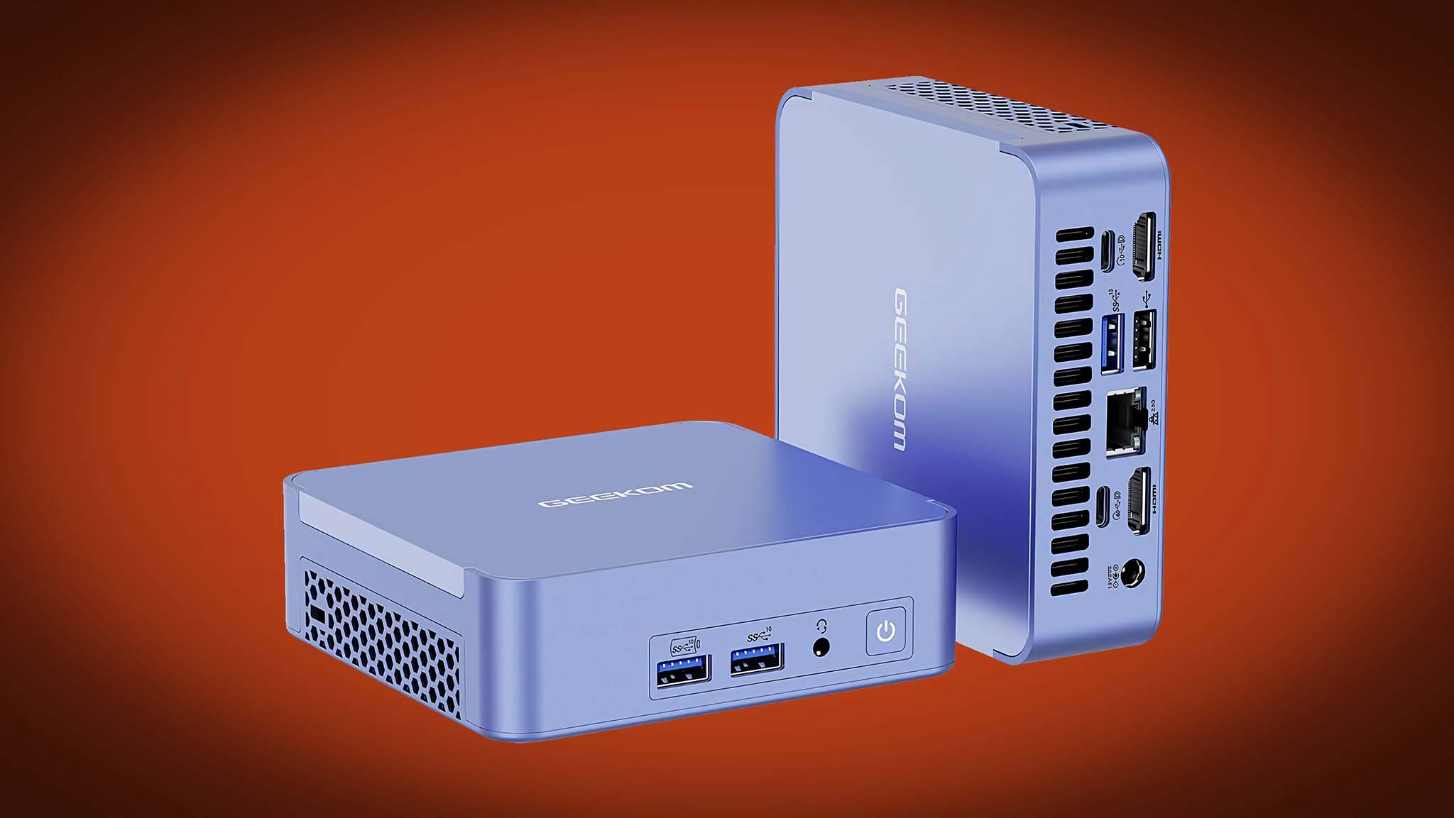 Geekom AX7 Pro mini PC on red background.